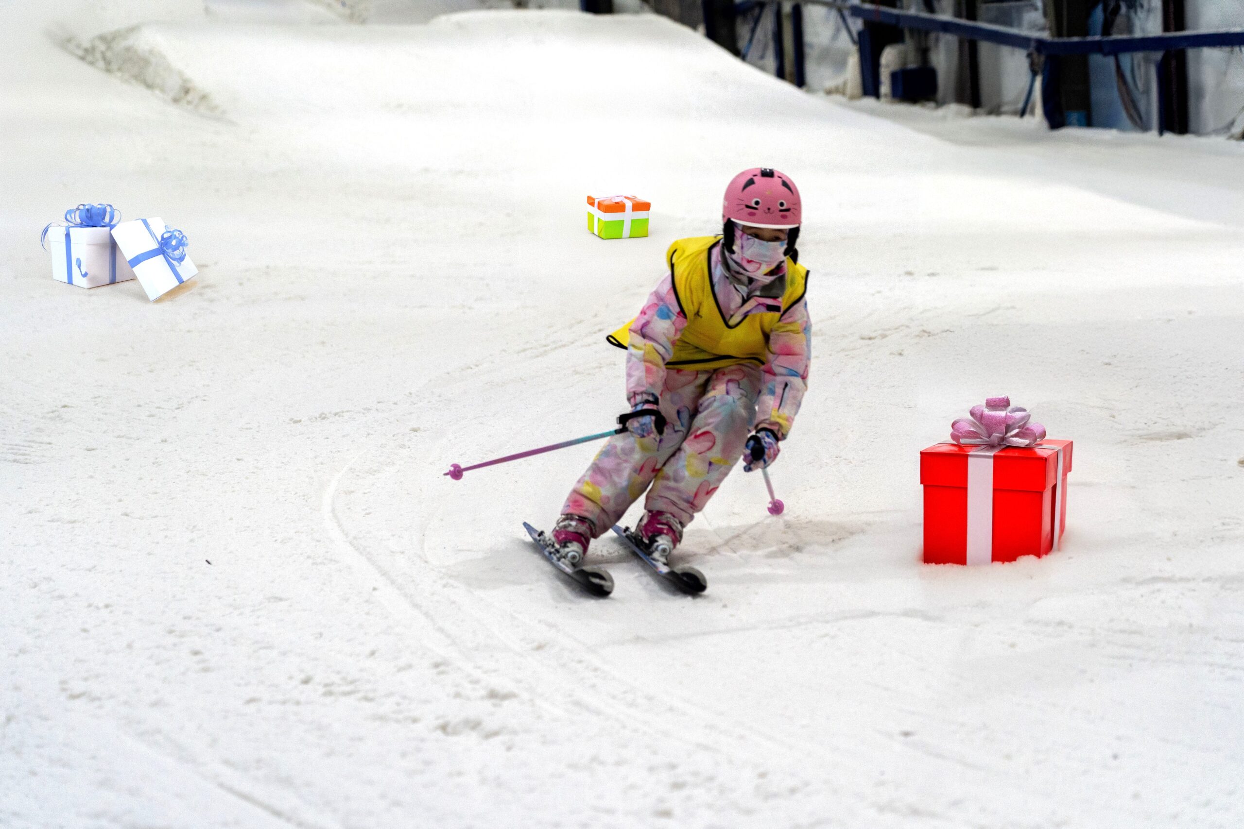 Young ski racer skis around Christmas Presents