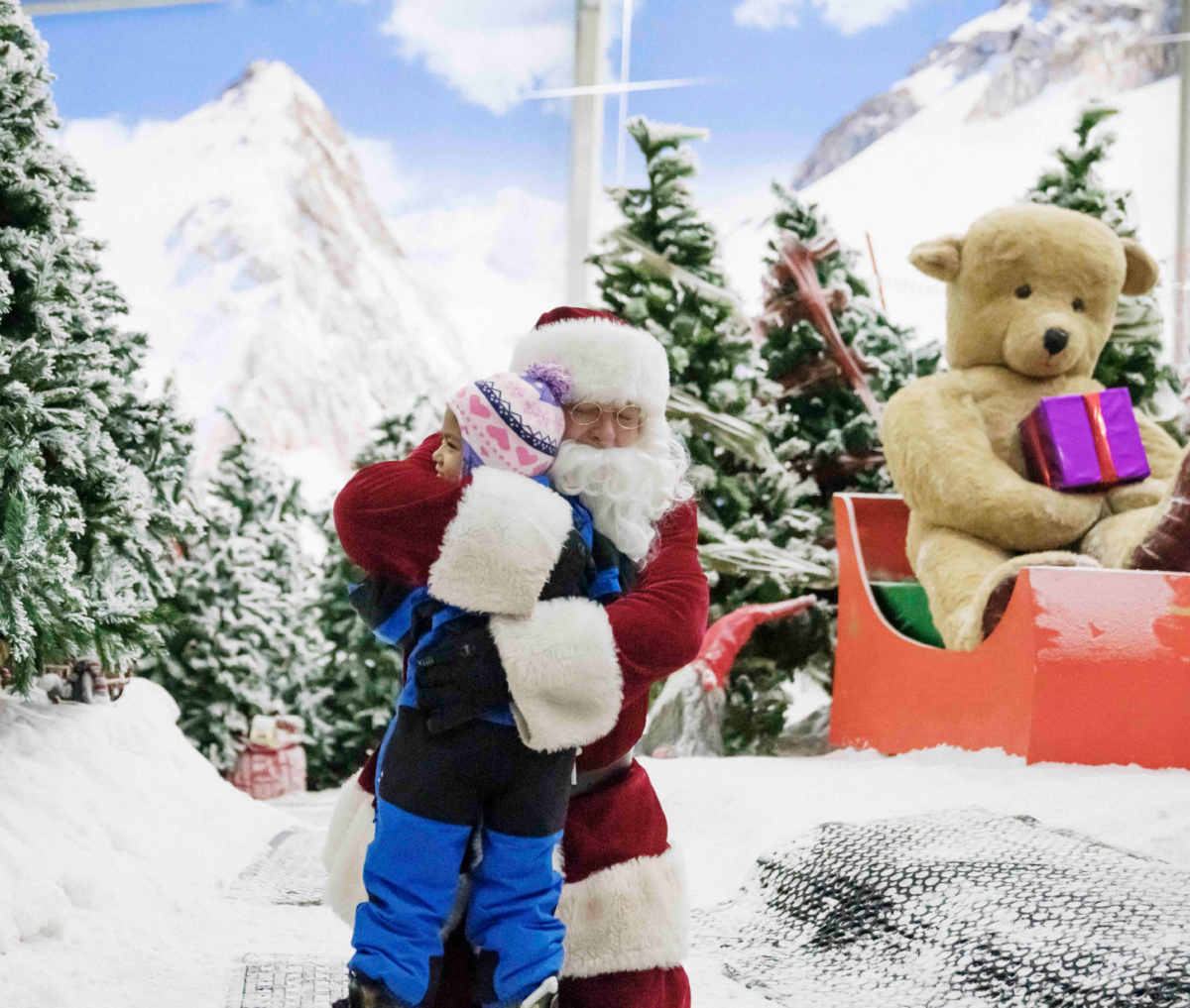 Child hugs Santa at Snowplanet