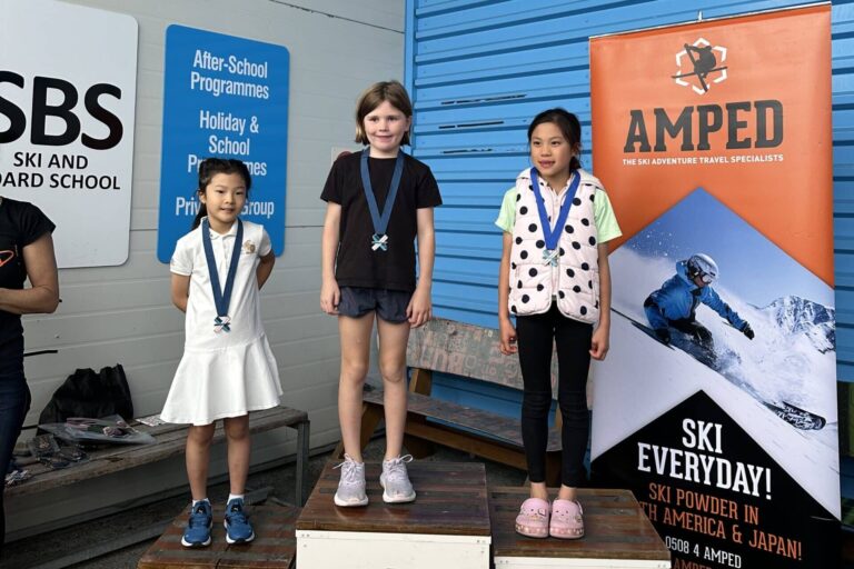 Winners of the Grand Slalom Race Event at Snowplanet stand on a podium