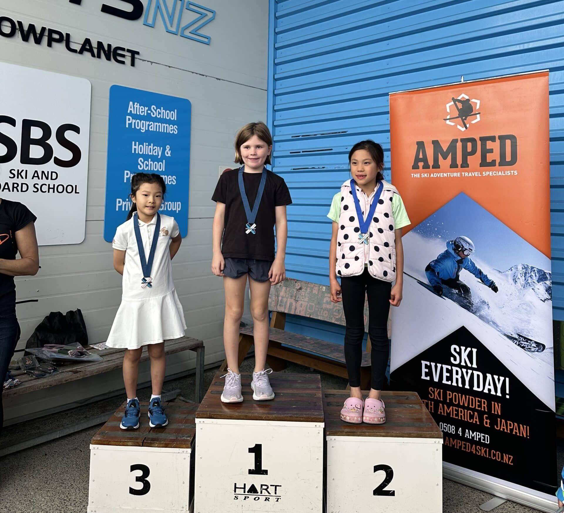 Winners of the Grand Slalom Race Event at Snowplanet stand on a podium