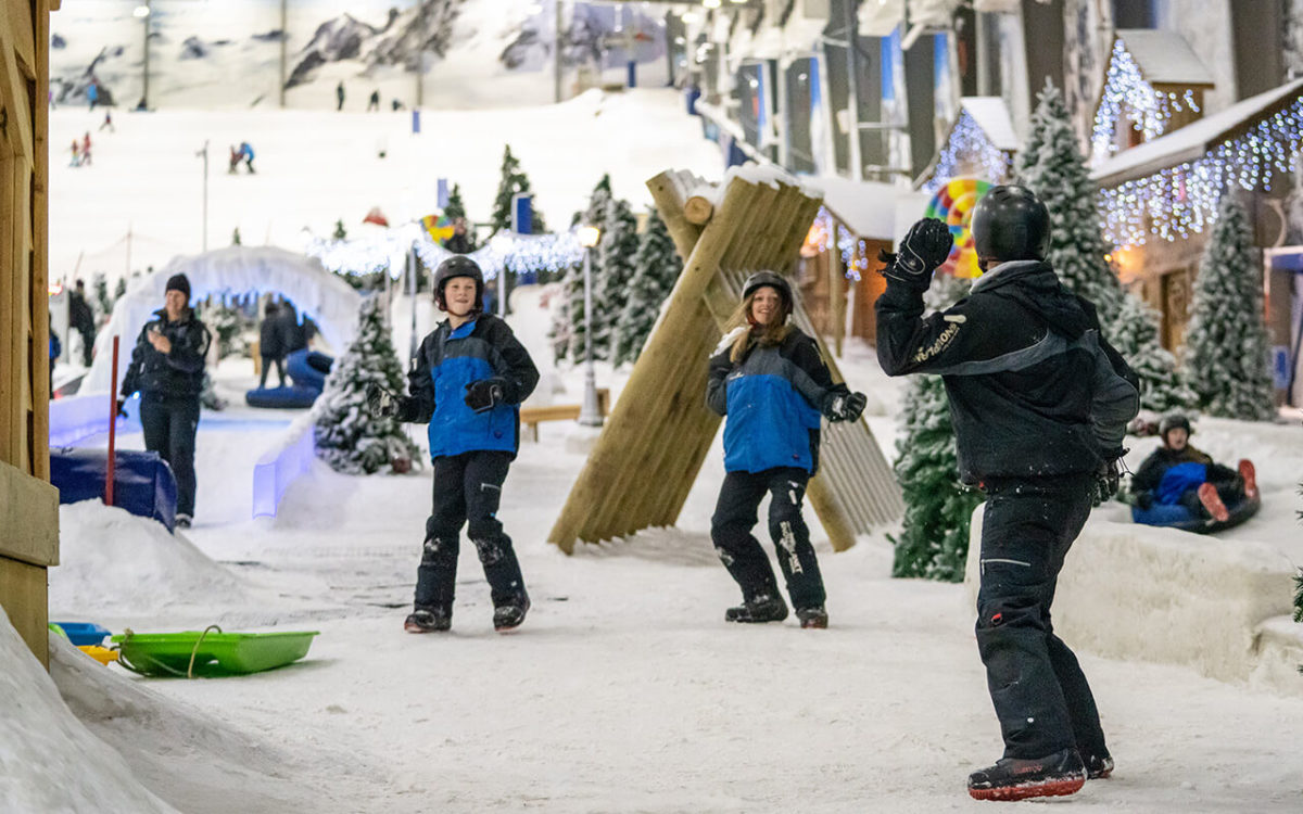Family snow fight at a Snowplanet birthday party in Winter Wonderland.