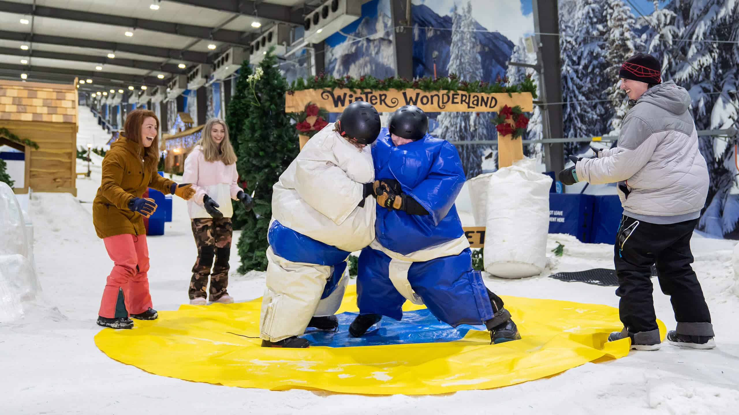 Company having a fun team building event at Snowplanet doing inflatable sumo wrestling in the snow.