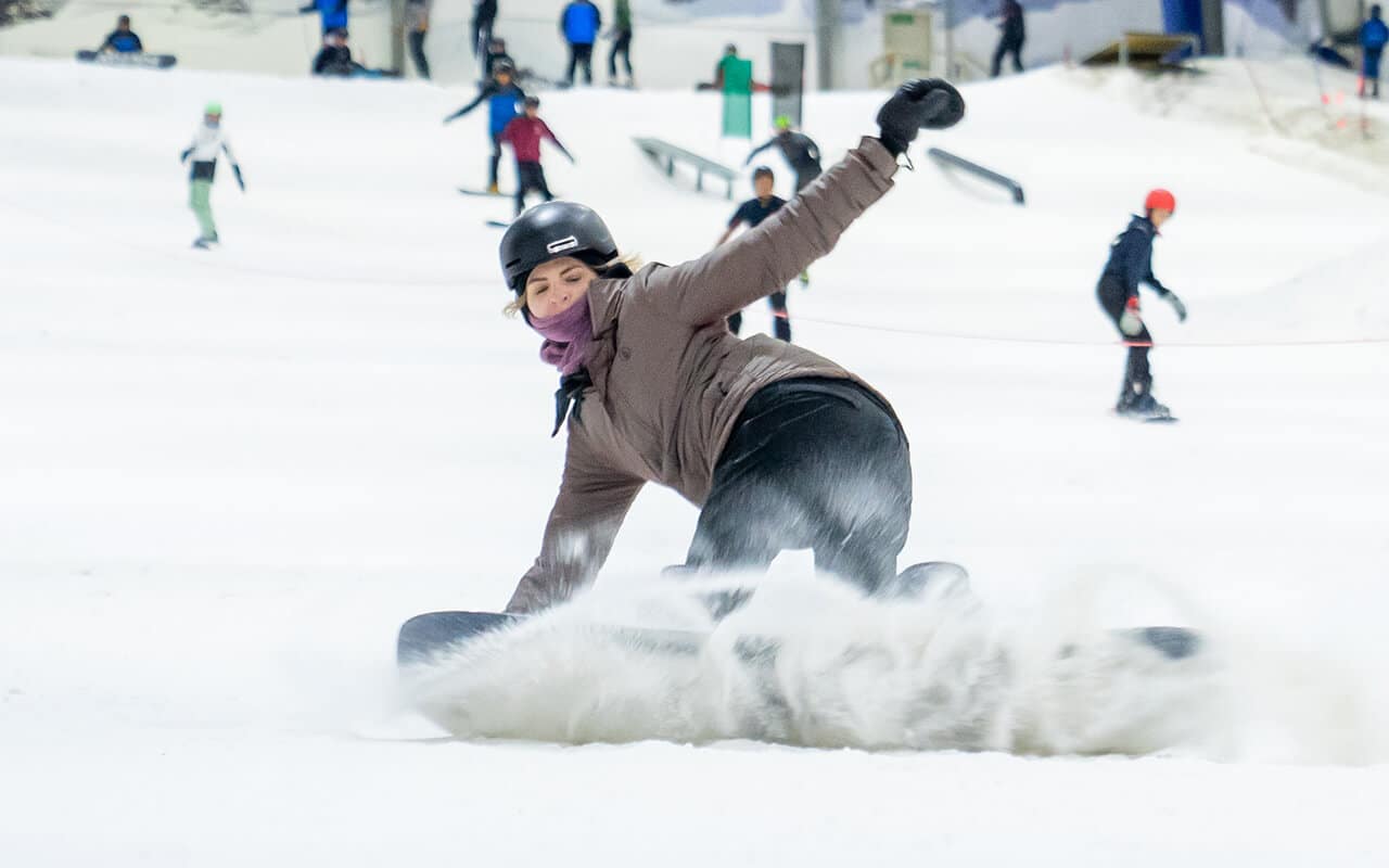 Woman snowboarding at Snowplanet after getting a gift voucher