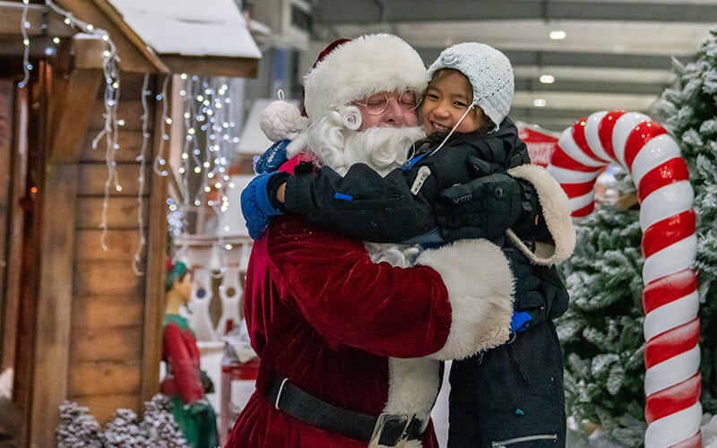 Happy ghirl hugs Santa