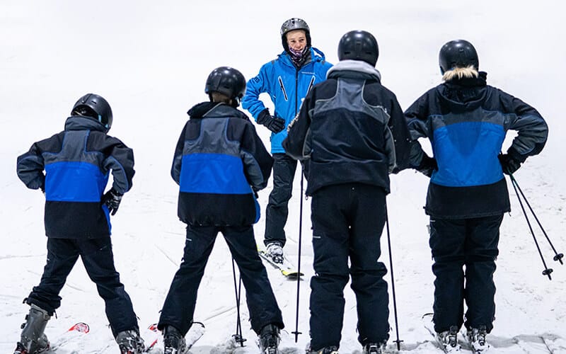 Snowplanet instructor gives a group lesson