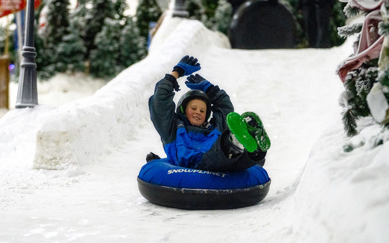 Boy snowtubing at Winter Wonderland in Snowplanet