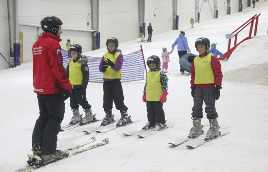 Kids getting a school holiday ski lesson at Snowplanet in Auckland